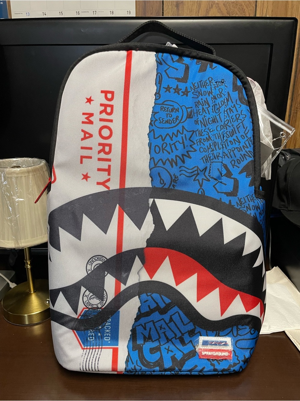 Sprayground Blue, White & Red Priority Mail Shark Print Backpack